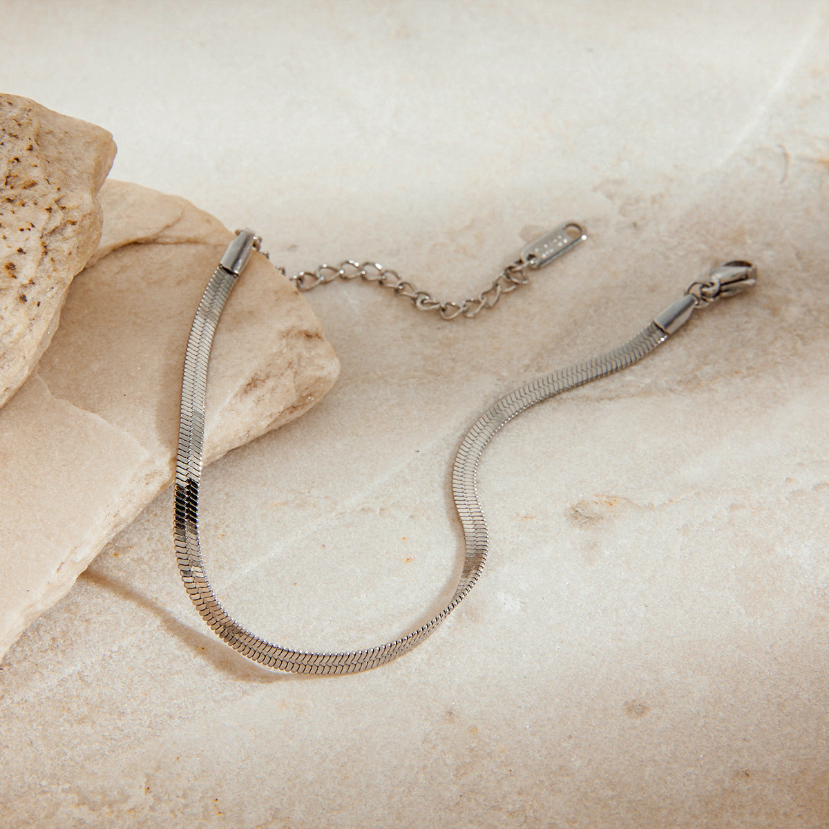 Polished Stainless Steel Oval Link Bracelet — bracelet laid flat on a neutral surface