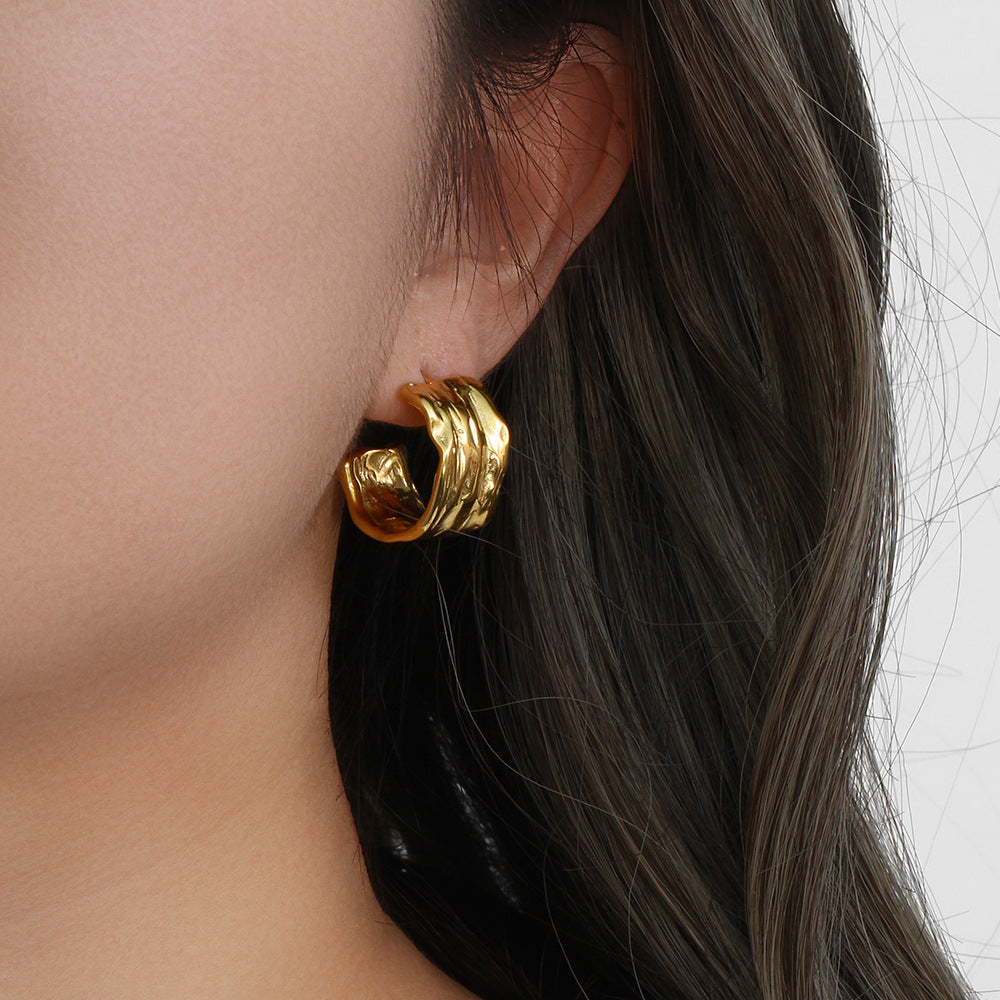 hammered 316L stainless steel C-hoop earring worn on the ear
