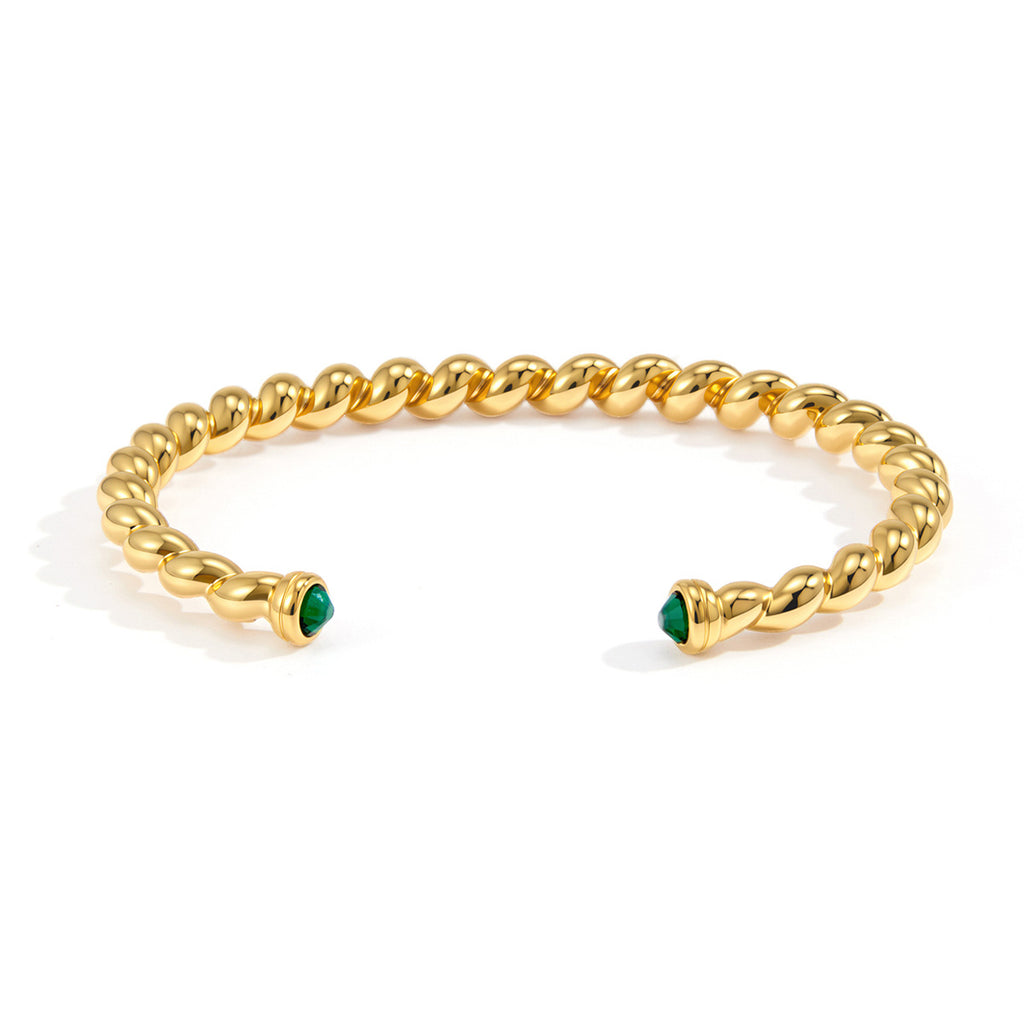 Front view of twisted stainless steel cuff with green stone terminals