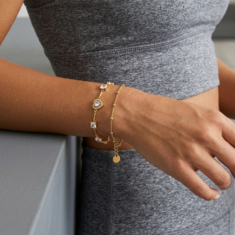 Mixed-cut heart bracelet layered on a wrist