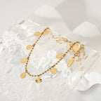 Beaded anklet with radial-pattern discs viewed diagonally