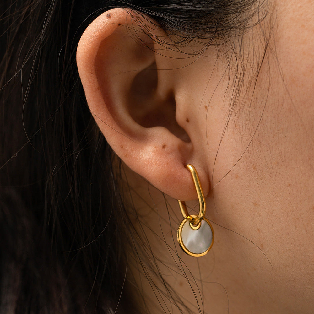 Gold plated stainless steel white disc drop hoop earrings worn view