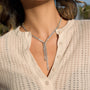 clear-stone Y necklace with asymmetric drops worn on model