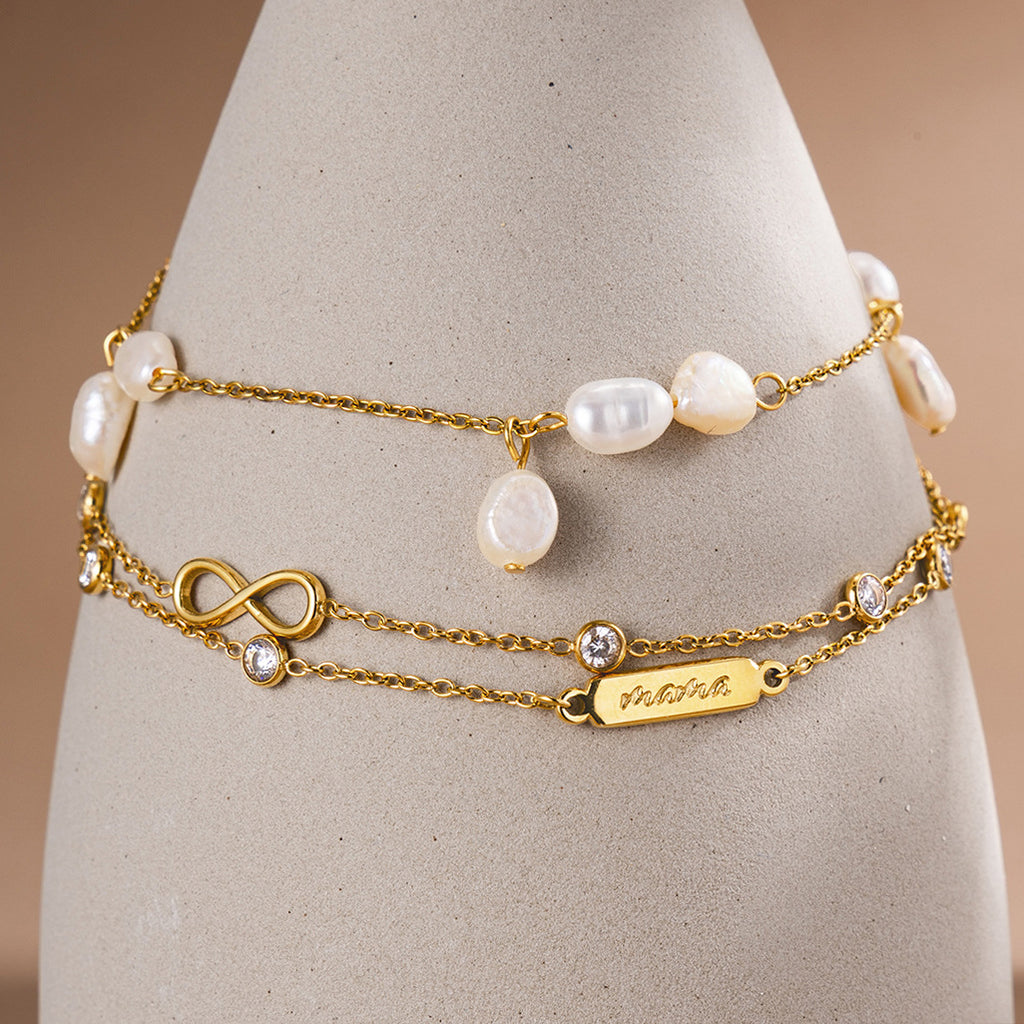 Natural pearl bracelet and double-chain infinity bracelet displayed together