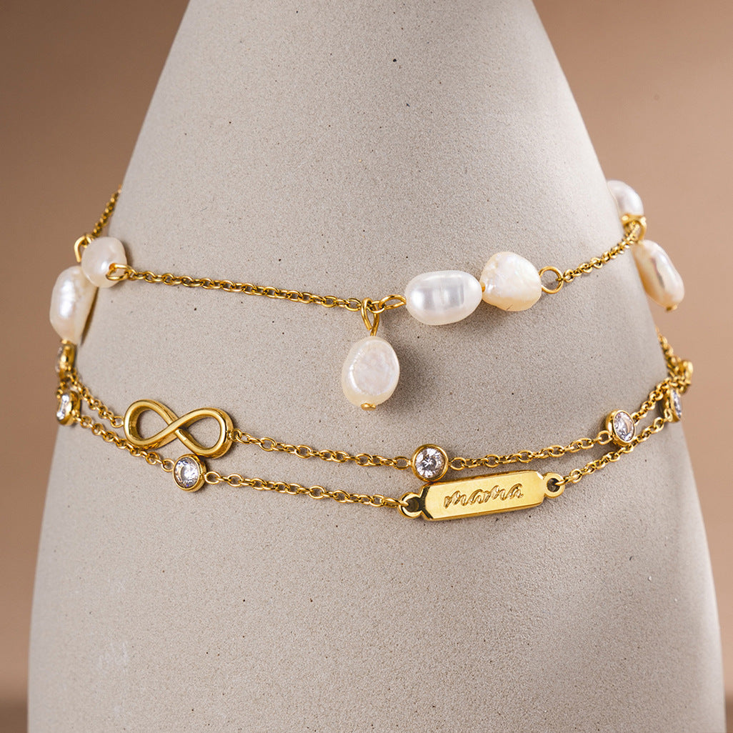 Natural pearl bracelet and double-chain infinity bracelet displayed together