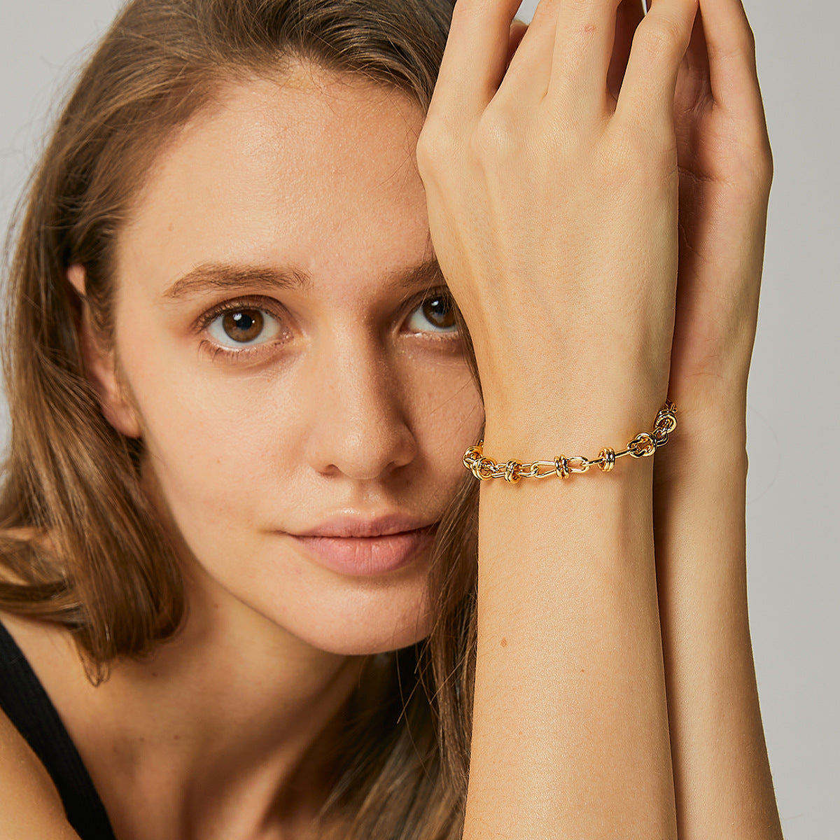 delicate gold plated bow-knot link chain bracelet worn on the wrist