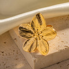 Gold-Tone Stainless Steel Sculptural Flower Ring Collection — detail view