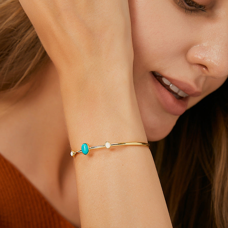 model wearing the turquoise-color three-stone open cuff bracelet