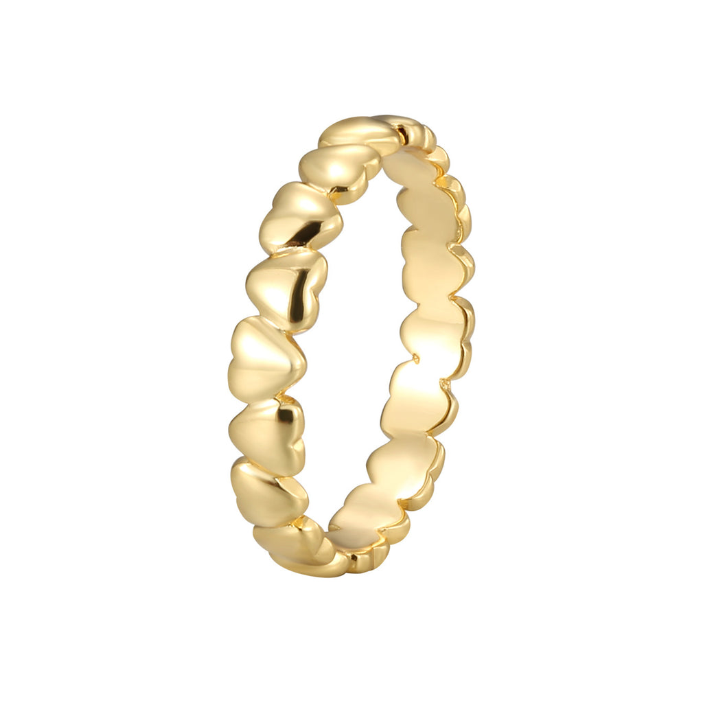 isolated gold plated brass heart band ring on white