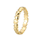 isolated gold plated brass heart band ring on white