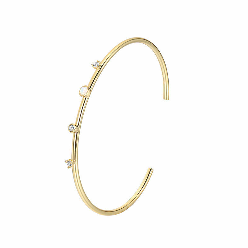 isolated open cuff with zirconia and white round cabochon