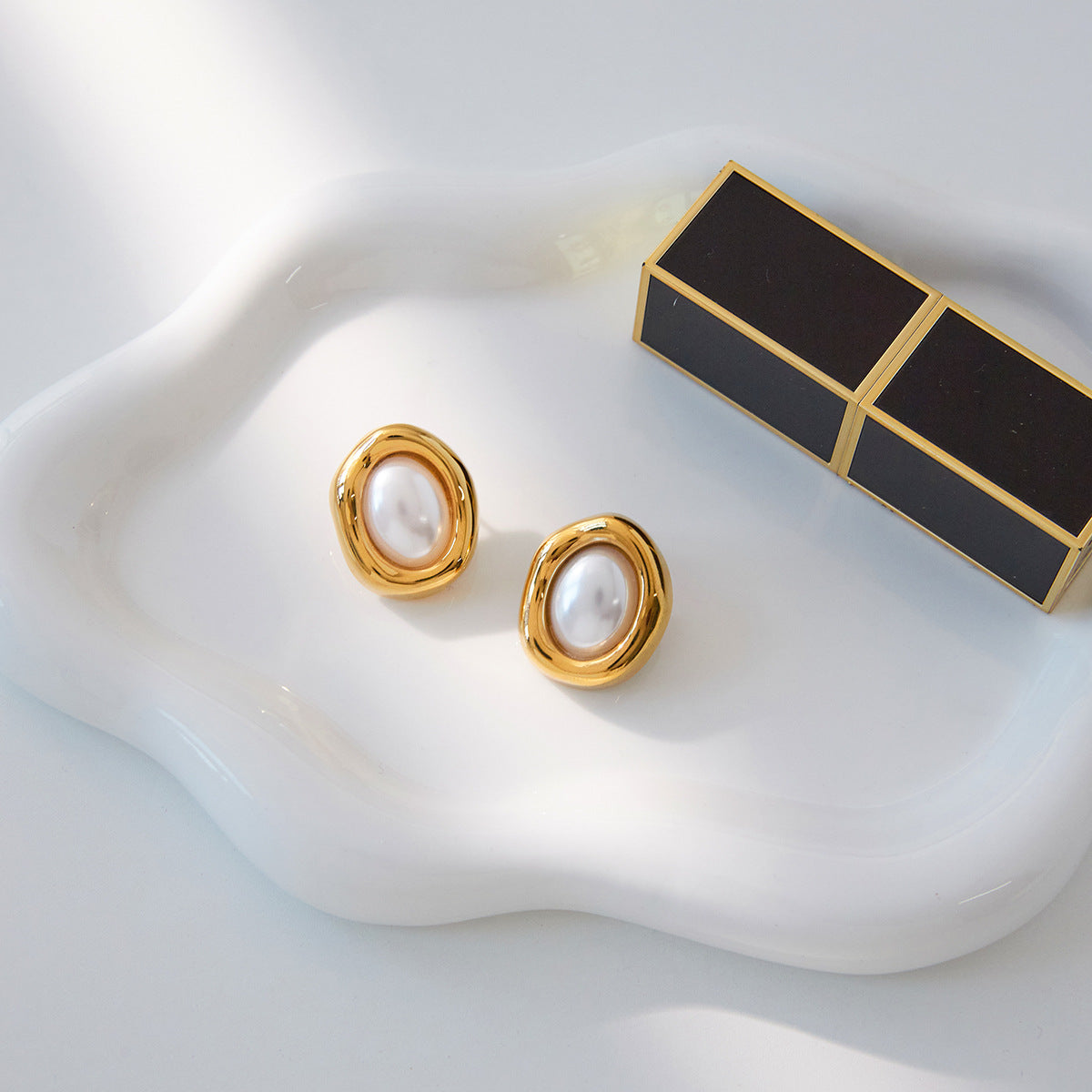 Gold Tone Pearl-Look Stainless Steel Oval Stud Earrings — paired earrings on a neutral surface