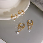 Two chain-drop hoop styles displayed on a gray surface