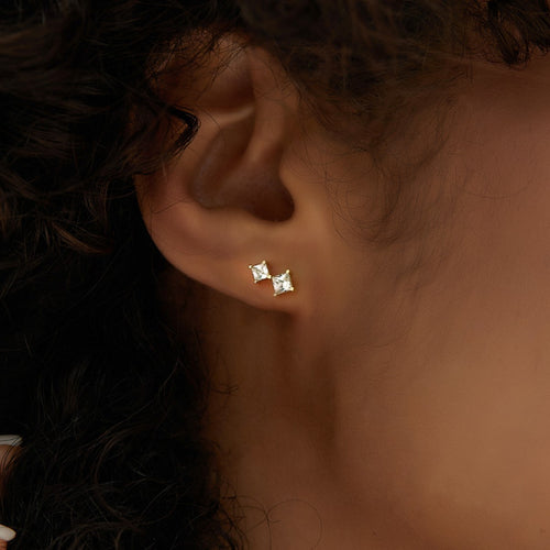 graduated square clear stone stud earring worn on the lobe