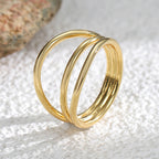angled close-up of three connected polished gold plated bands