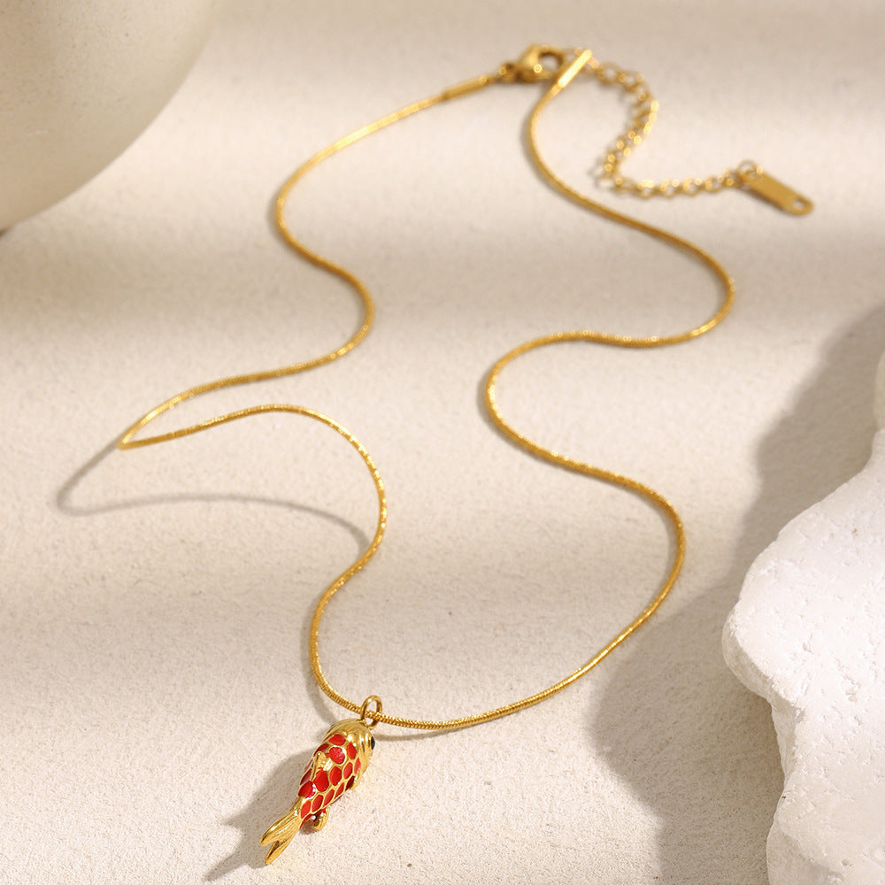 Red scale fish necklace laid out with its extender