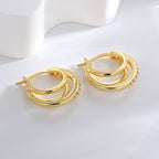 three nested gold plated hoops with clear stone-set outer edges