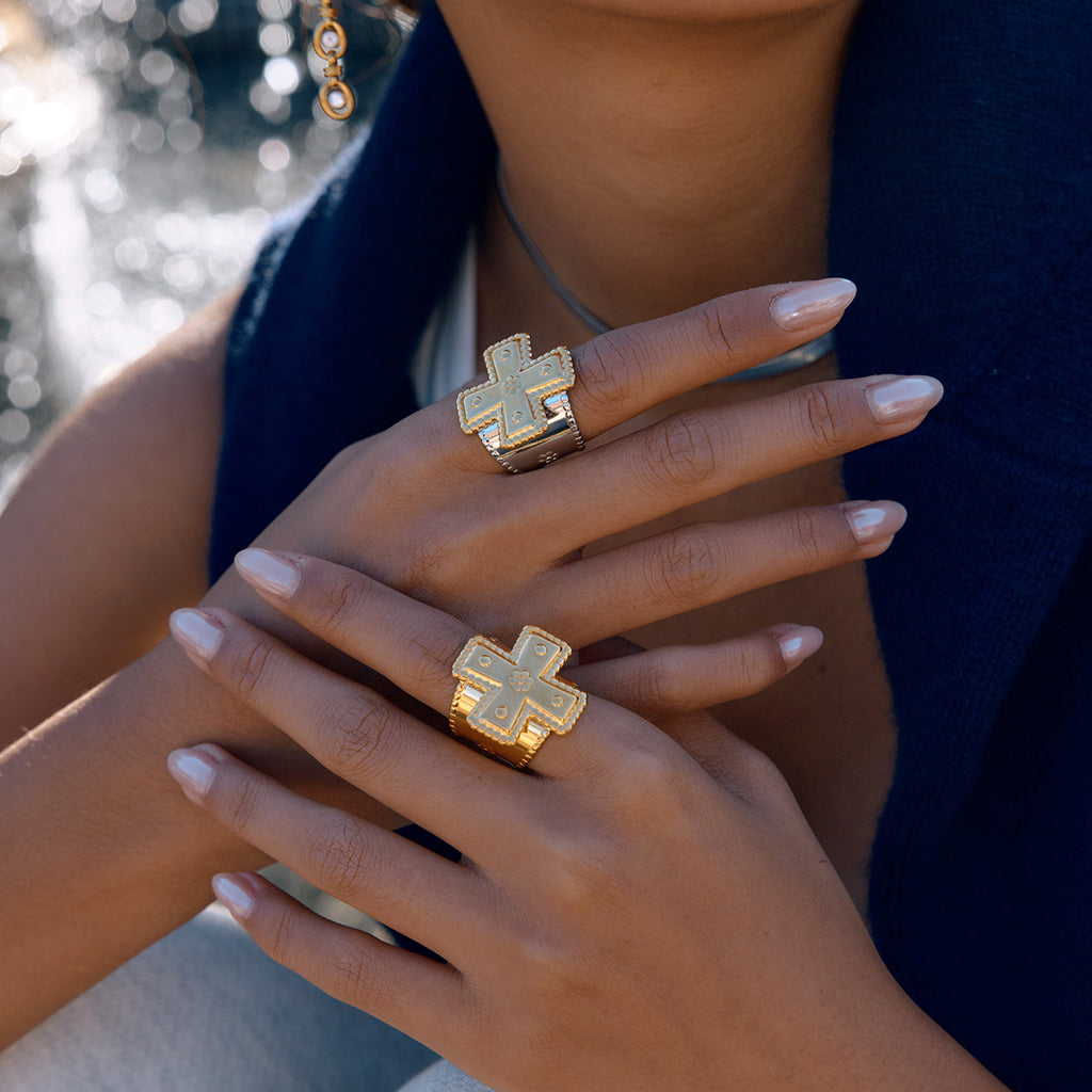 model wearing gold plated and two-tone cross statement rings