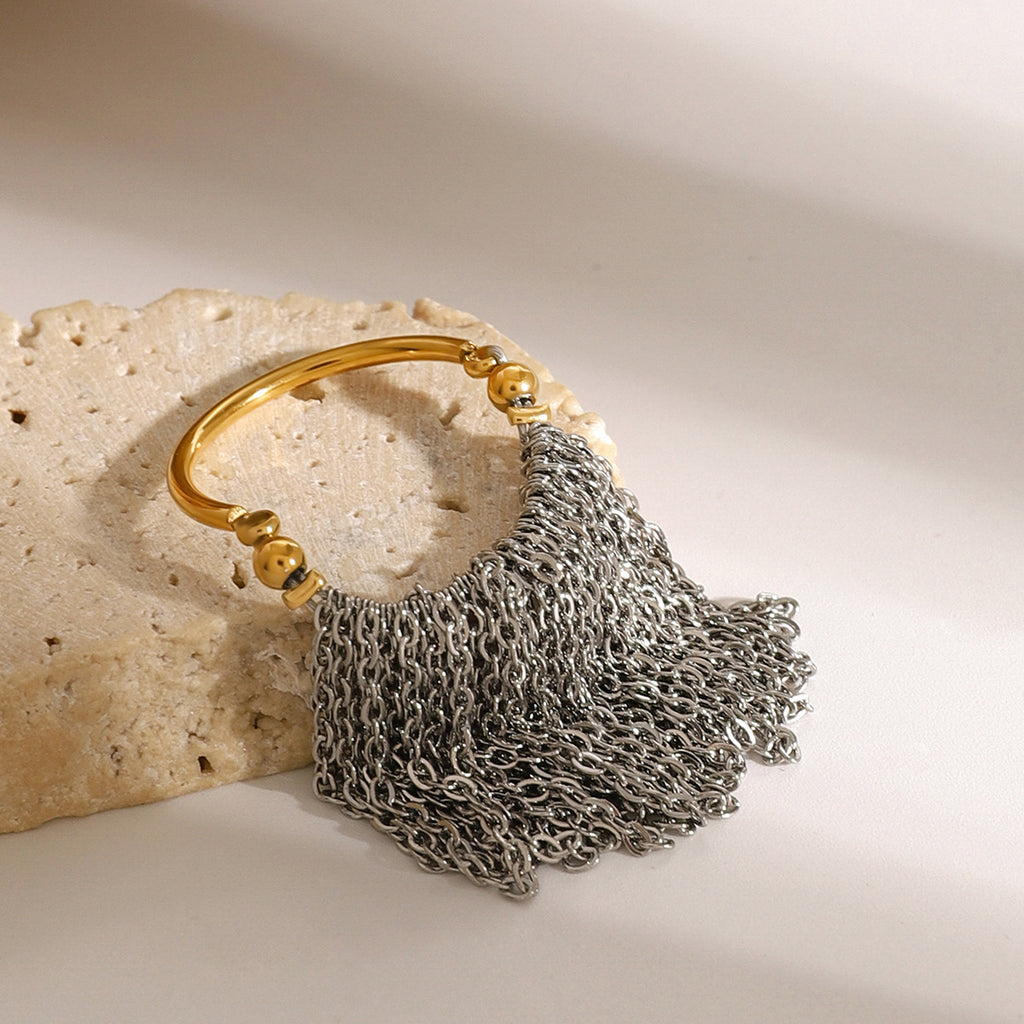 Two-tone chain fringe ring displayed on stone