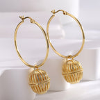 large round hoops with ribbed caged-orb charms standing upright