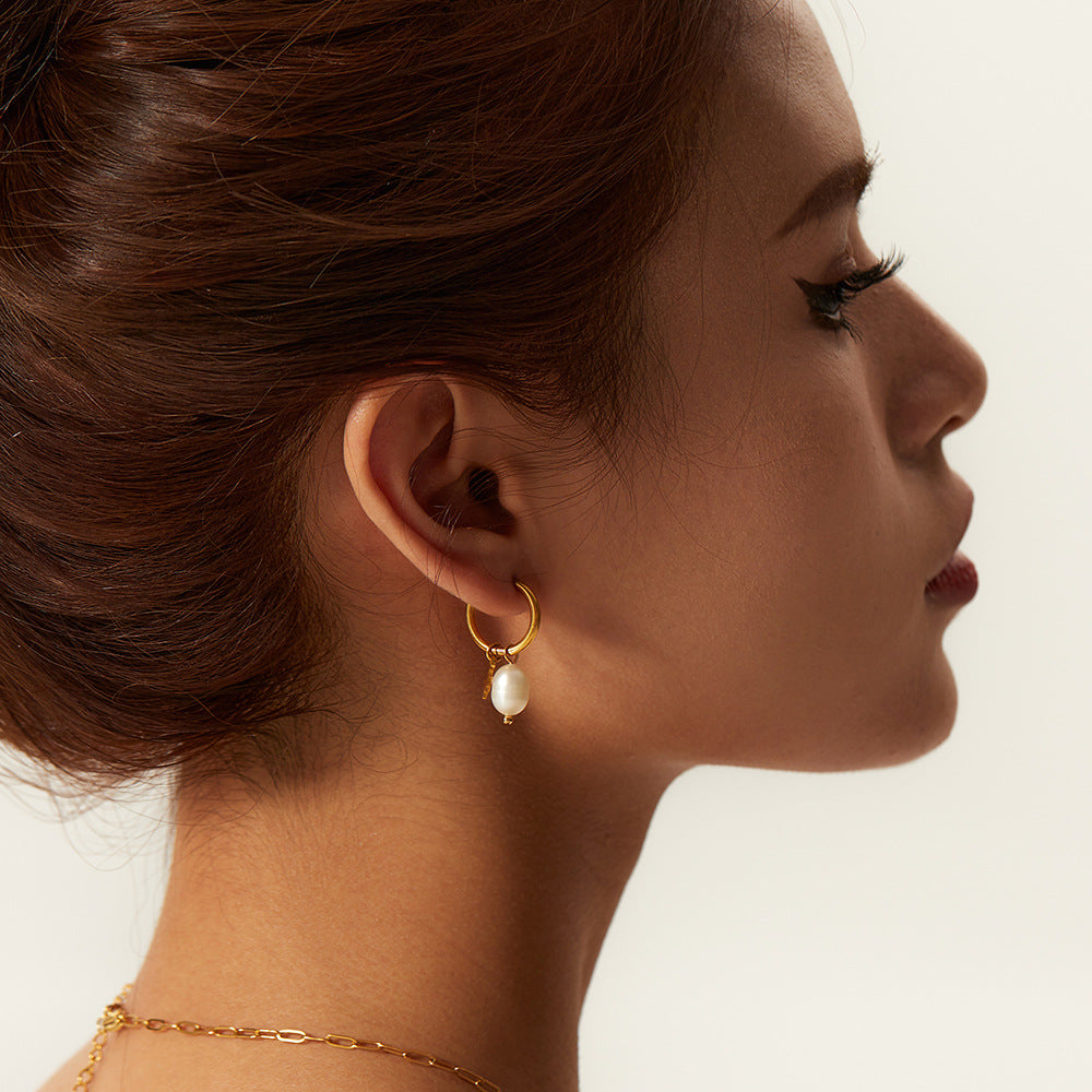 Freshwater pearl drop hoop earring worn in profile