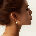 Freshwater pearl drop hoop earring worn in profile