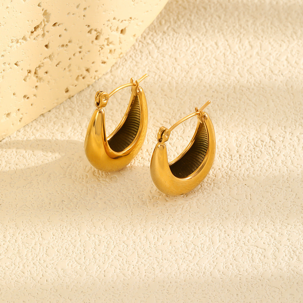 Tapered gold plated hoops shown at an angle