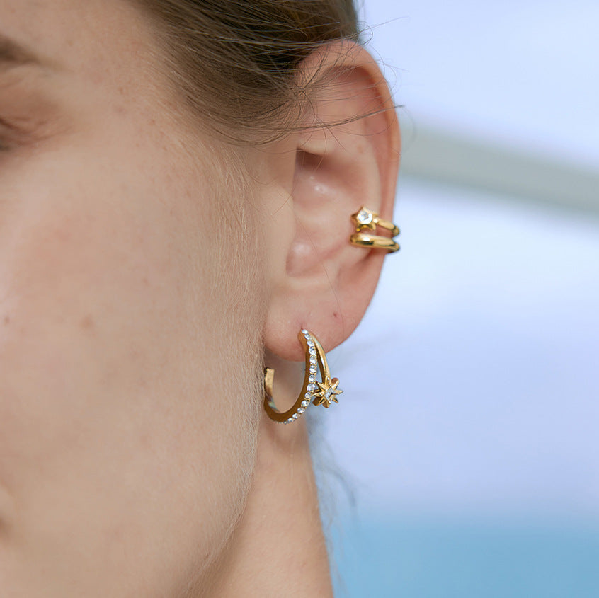 Starburst hoop earring shown close-up on ear