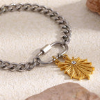 Steel curb chain beside gold plated charm