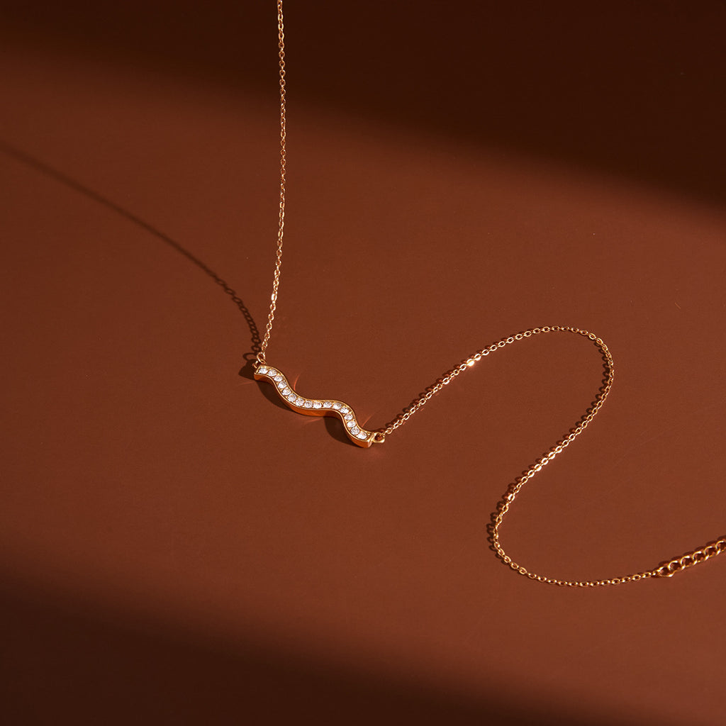 clear-stone double-wave necklace in warm light