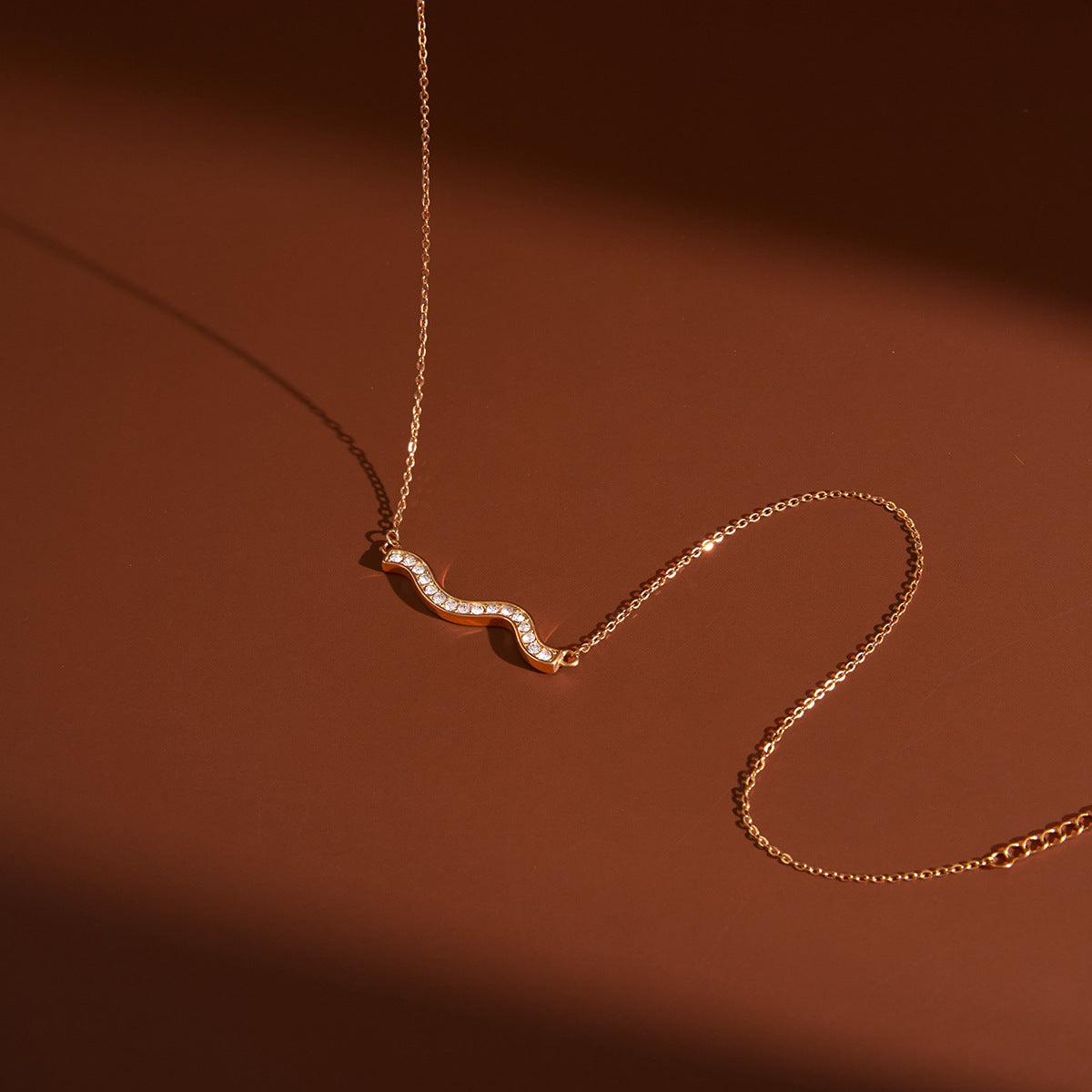 clear-stone double-wave necklace in warm light