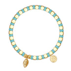 isolated turquoise-color cube bead bracelet with cowrie charm