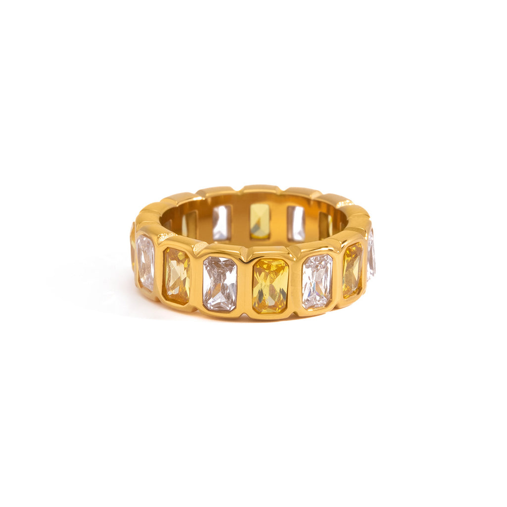 Alternating clear and yellow stone ring on white