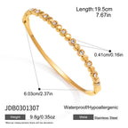 Gold tone bangle with alternating round metal and clear accents
