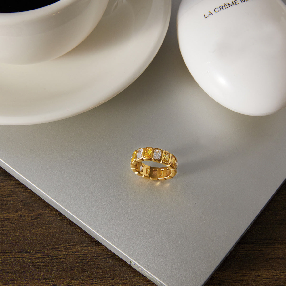 Gold-tone stone band beside a cup