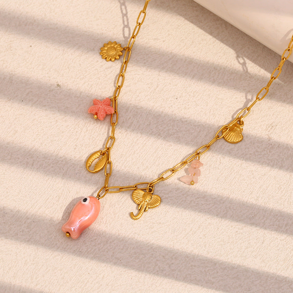 pink fish starfish shell and palm charms on an elongated-link chain