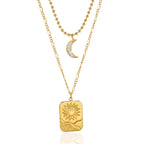 Clear-stone crescent and rectangular sun pendant on white