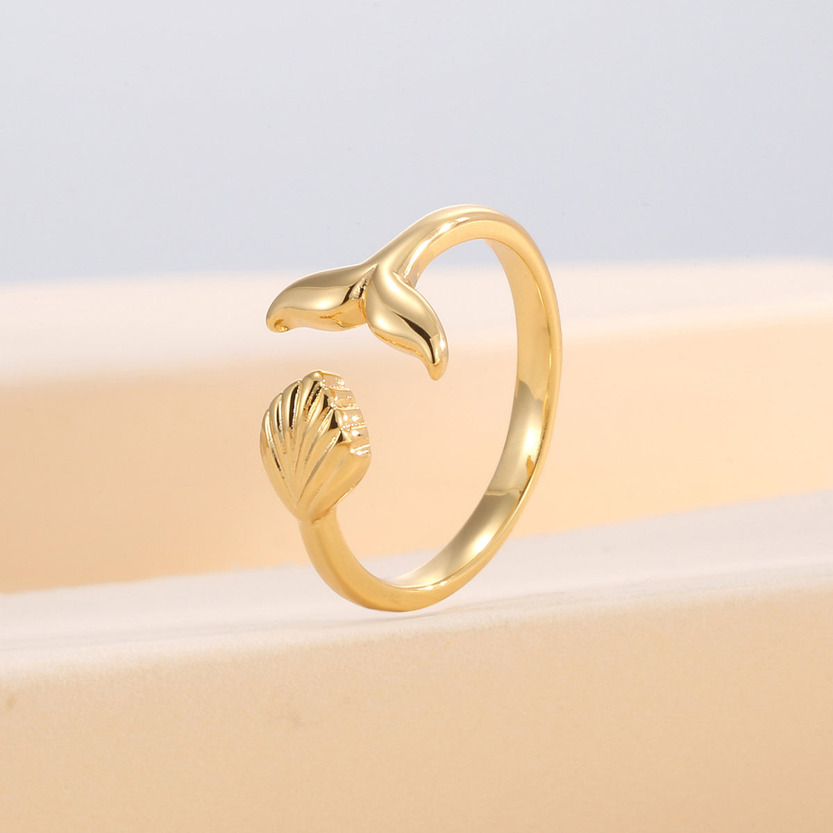upright view of the whale-tail and seashell ocean ring