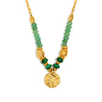 isolated green bead and textured coin pendant necklace on white