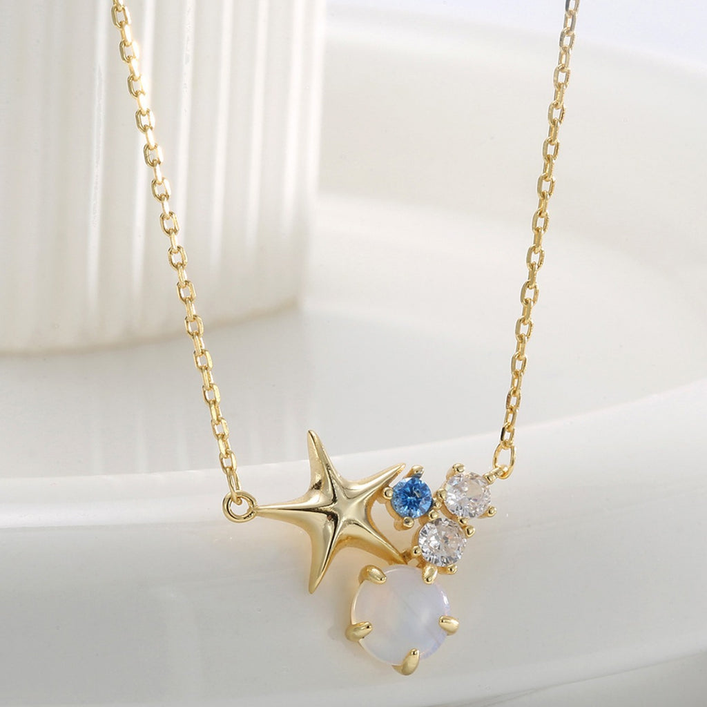 angled view of star necklace with blue clear and white accents
