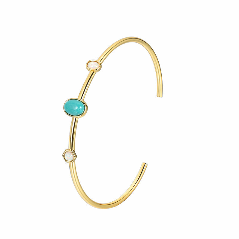 isolated gold plated brass turquoise-color cuff bracelet