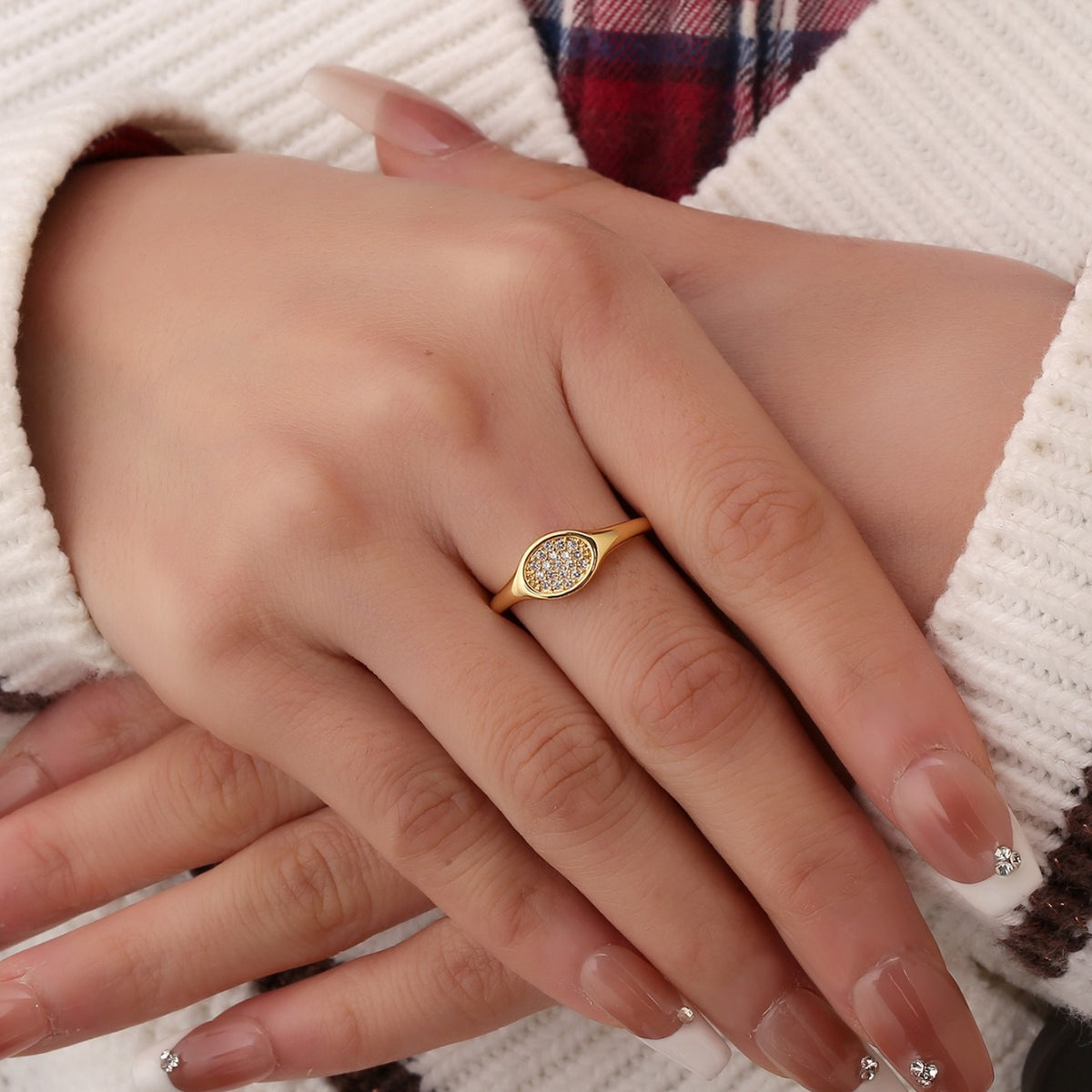 model wearing a compact clear-stone oval signet ring