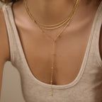Three-layer beaded Y-necklace shown at neckline