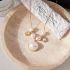White bead and rectangular clear accent necklace displayed on a dish
