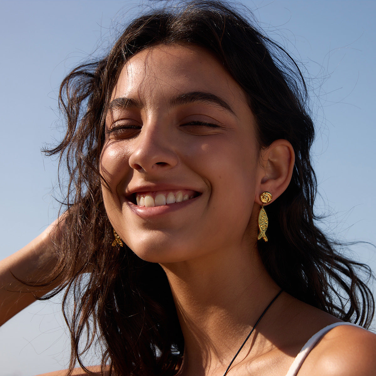 Fish drop earrings styled outdoors