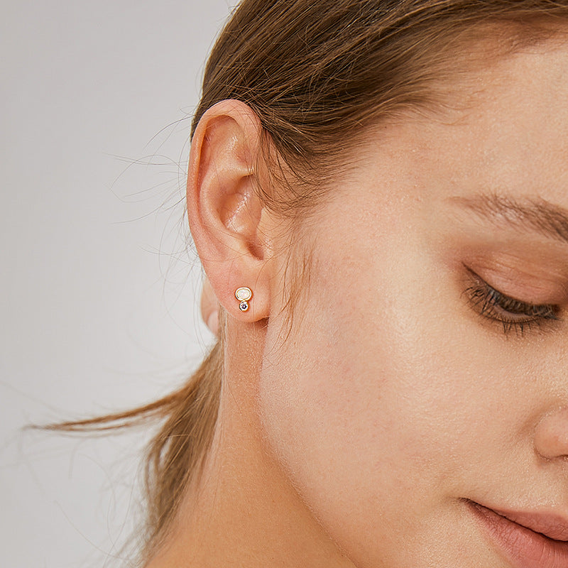 petite opal and purple stone studs worn on the ear