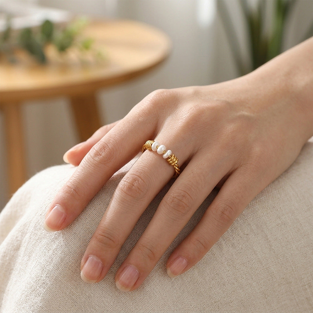 Pearl-accent ring worn on a hand