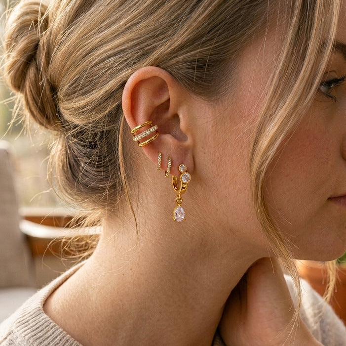 Pear-drop huggie worn in an ear arrangement