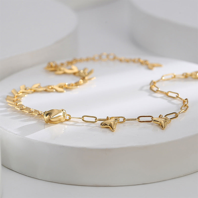 chevron and paperclip-style chain anklet on white display