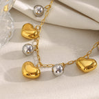 close view of gold plated puffy hearts and polished silver beads